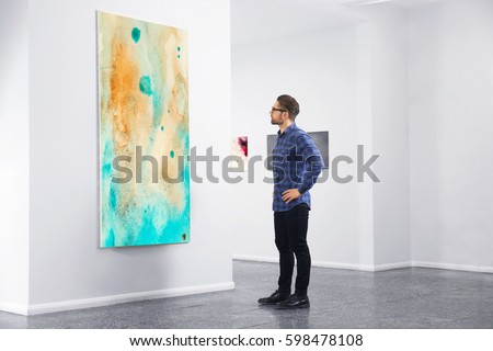 Young man in modern art gallery
