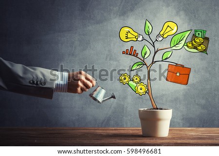 Hand of businessman watering concept of business plan and strategy