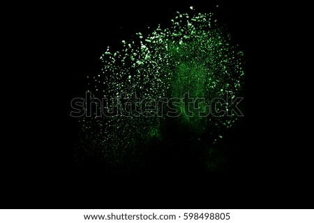 Freeze motion of color powder coming down on black background,Abstract design of falling dust cloud,artificial snow fall concept.