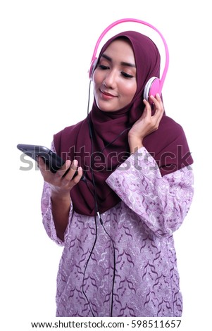 Muslim Woman listening music in headphones with white background
