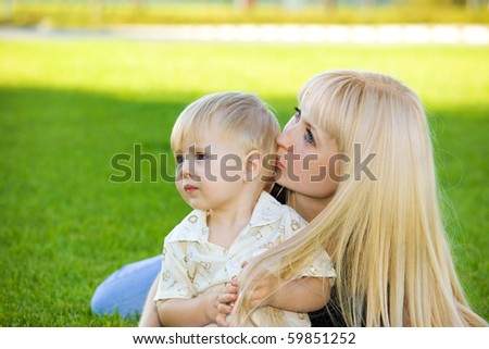 Loving mom kissing her toddler  son