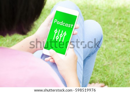 Top view of woman using her mobile phone with multimedia music broadcast technology concept