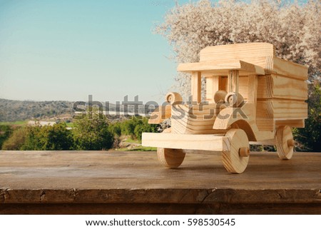 old wooden toy truck car over wooden table. nostalgia and simplicity concept. vintage style image