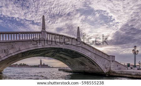 A typical Venetian bridge, Ponte San Biasio delle Catene, in the historic center of Venice, Italy, under which you can see the island of San Giorgio Maggiore