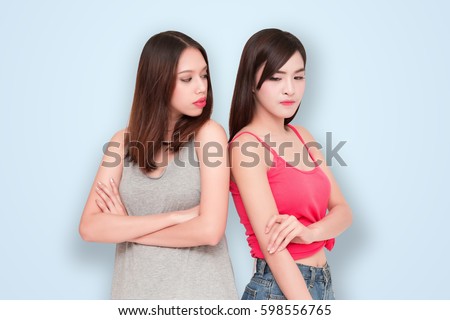 Two girls looking each other angry  Royalty-Free Stock Photo #598556765