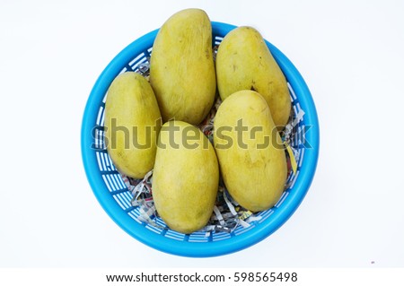 Close up of photo of very fresh ripe mangoes in blue basket isolated on white background (Thai alphabet in the picture are slice of newspaper which became broken words and have no meaning)