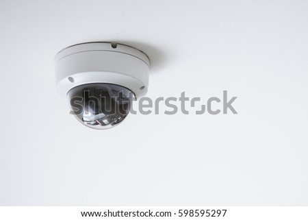 CCTV camera on white ceiling Royalty-Free Stock Photo #598595297