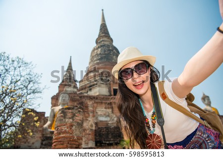 asia travel selfie Asian woman in Ayutthaya village, Bangkok. Cute happy smiling tourist girl taking self-portrait picture with smartphone during summer vacation in famous asian destination, Thailand.
