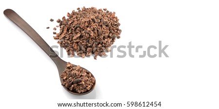 Cacao nib in wooden spoon over white background