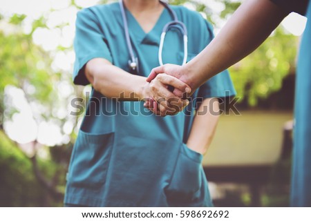 Surgeon medical people handshaking. Cross processing and Split tone instragram like process. Royalty-Free Stock Photo #598692692