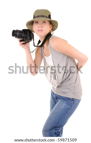 Casual smiling girl-tourist in jeans with professional digital photocamera is looking for picture isolated on white background