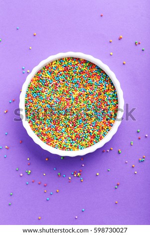 Colorful sprinkles on a purple background