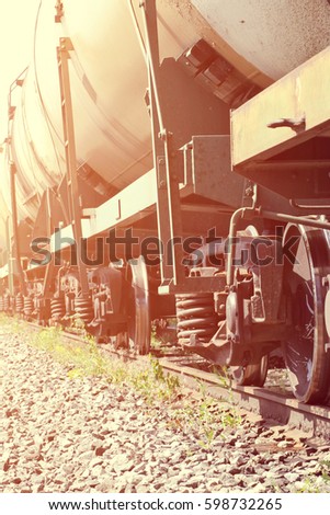 Railroad train of black tanker cars transporting crude oil on the tracks, with instagram style filter, toned photo 