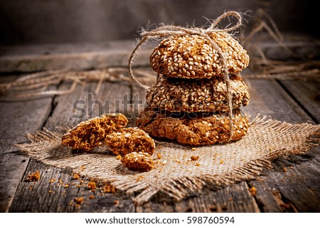 Homemade cookies with sesame, dark wood background, selective focus
