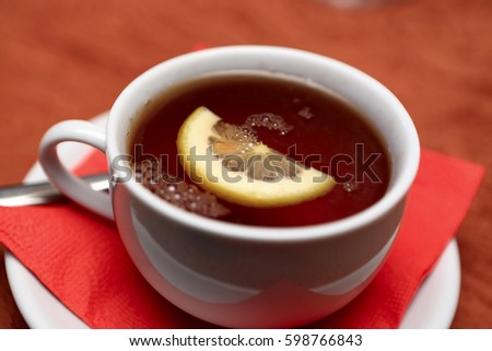 Cup of tea with lemon on a table