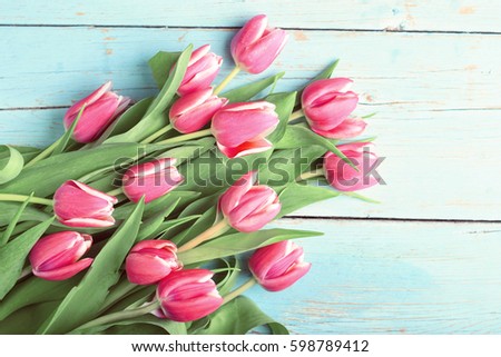 Bouquet of tulips on vintage wooden table