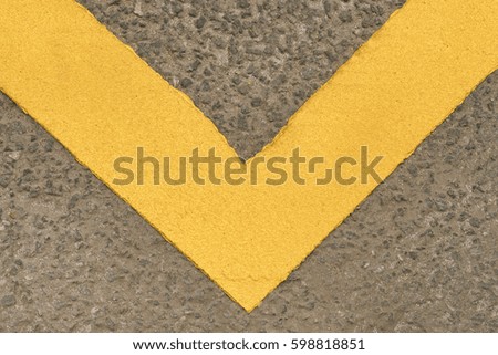 Gray asphalt surface with yellow stripes, texture, background