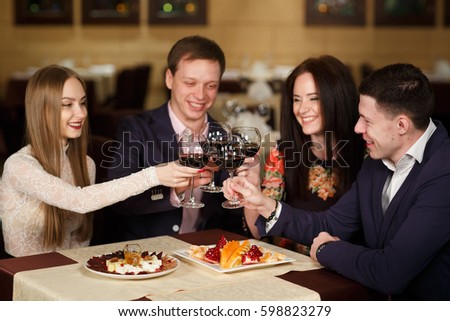 Friends at a restaurant drinking wine.
