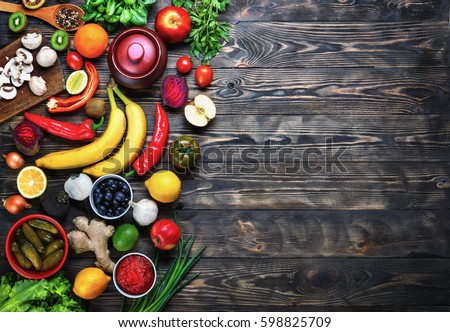 
Vegetables and fruits on a dark rustic wooden table. Healthy vegetarian food. Royalty-Free Stock Photo #598825709