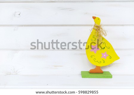 easter card with colorful  easter eggs and wooden yellow chicken 