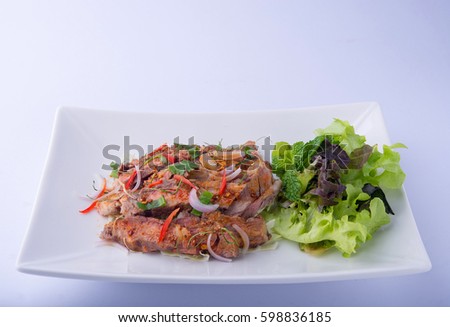 Spicy sliced beef salad on white dish , white background , Thai Food