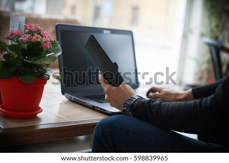 Man with computer shopping online.Under exposed photo
