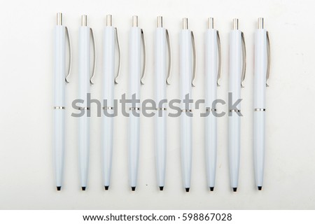 white pens on white background