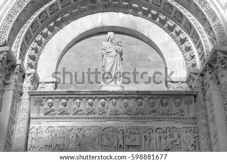 Beautiful bas-relief above the entrance to the Baptistery of San Giovanni in Pisa, Italy. Black and white photography