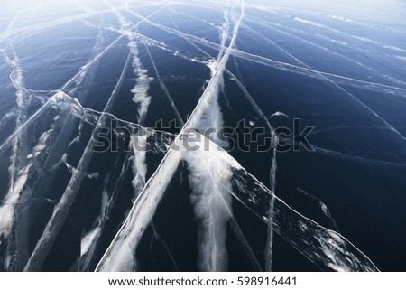 Cracks in ice of Baikal lake. Winter texture
