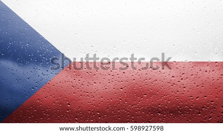 Czech Republic flag outside the window with raindrops on the glass