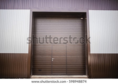metal texture brown and white siding close gates