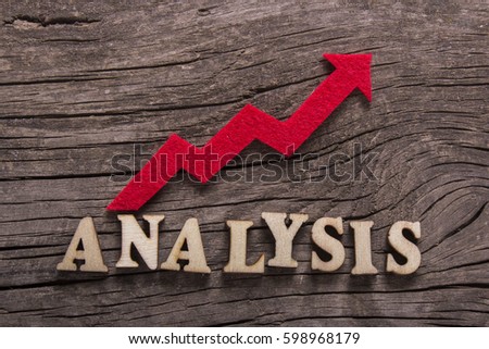 Word analysis of wooden letters and graphics up on an old wooden background

