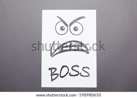  Evil painted boss face on a white paper on gray background