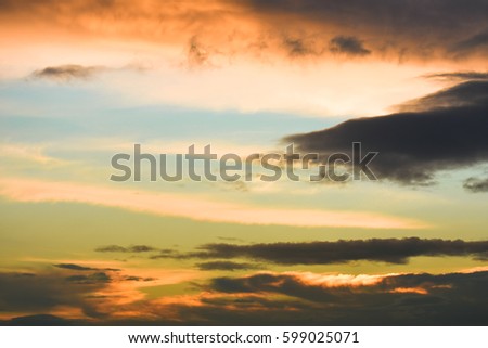 Blue sky between orange clouds. Sunset with clouds.