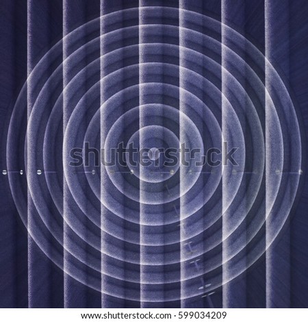 Target against unknown future. Concentric diagram being projected onto blue blinds / shutters. Conceptual image on the subject of goal setting, motivation, leadership or similar business matters