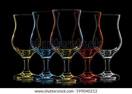 Silhouette of multicolor color cocktail glass on black background.