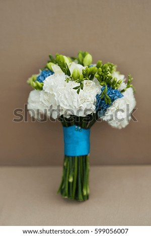 Beautiful bridal bouquet tied with blue silk ribbons. Wedding Accessories