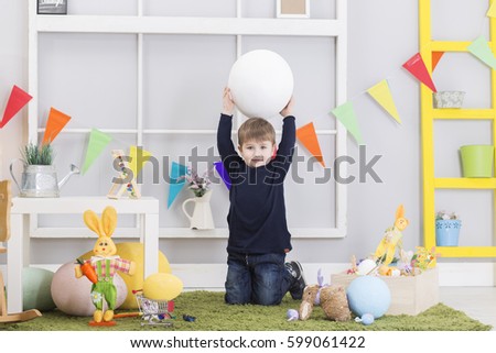 Happy Easter! Happy baby boy playing on Easter day. Easter decoration