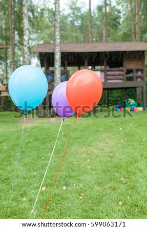 three color party baloons outdoors
