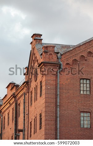 Old industrial factory made of weathered reddish bricks