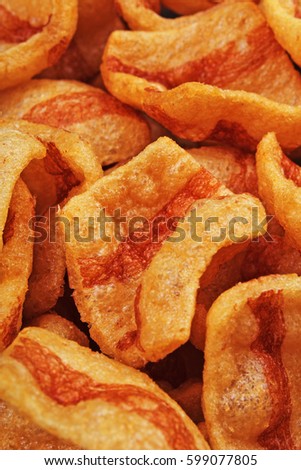 
Bacon flavored snacks. Bacon chips flips background pattern texture.