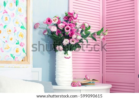 Beautiful bouquet in vase on bedside table