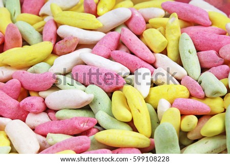 Candy from puffed rice grains. Sweet flavored puffed rice grains. Colorful snack.