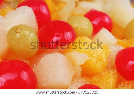 Fruit salad texture. Fruits as background pattern. Exotic Fruits  Fruit salad with cocktail cherry sour cherry mango pineapple grapes,pear,papaya in syrup.