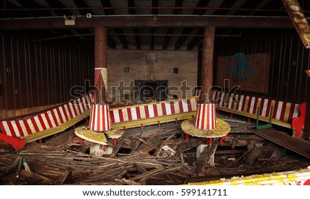 Crumbling interior of an abandoned ice skating rink.                               