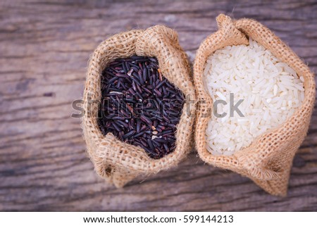 Black rice and Raw grain white rice  on banana leaves background,Jasmine rice,organic rice berry