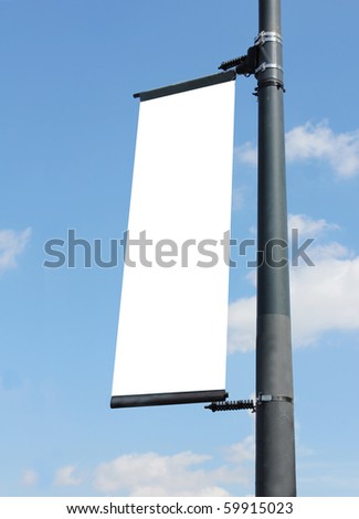 blank poster on lamppost with blue sky
