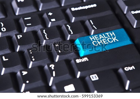 Close up of computer keyboard with text of health check on the blue button