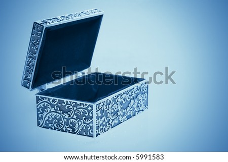 Old cyan metallic retro casket with reflection. Image with vignette effect