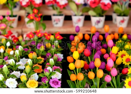 Closeup of colorful little flowers in flowerpots arranged in rows for home decoration